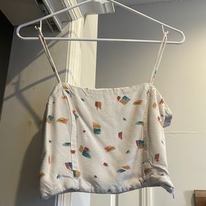 small white oneil top, with blue yellow and red pattern